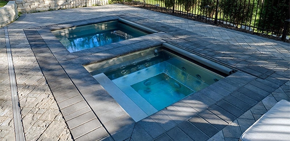 two plunge pool with interlock surface and aluminium fence in yard