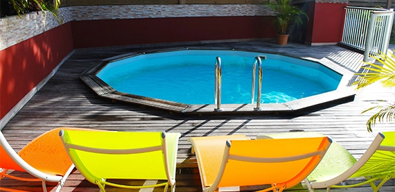 plunge pool with deck and chairs on deck