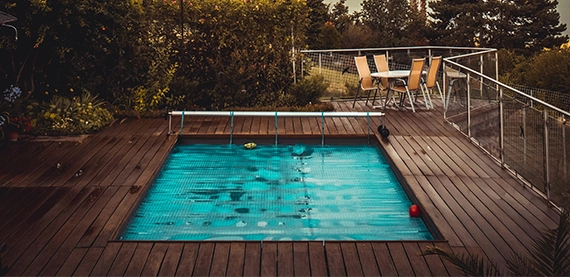 plunge pool with wooden above ground deck and sitting setup