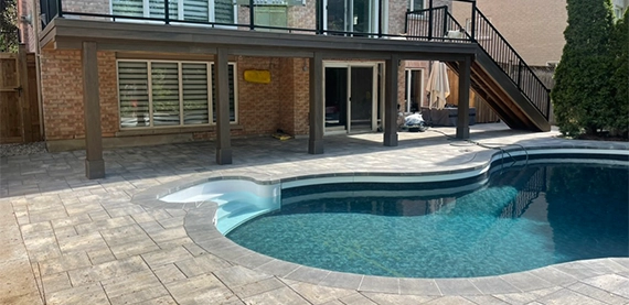 interlocking surface around pool and pool copying in backyard