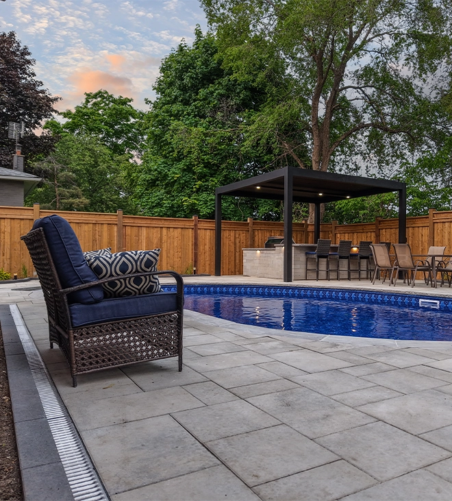 pool interlocking surface with water drainage system pool with interlock surface in backyard, open kitchen, water drainage system, wooden fence covered full yard with landscaping