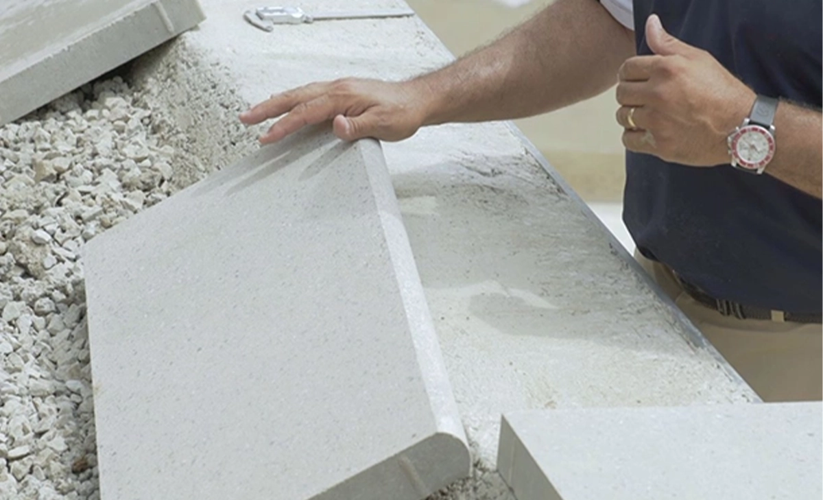 professional man installing pool coping