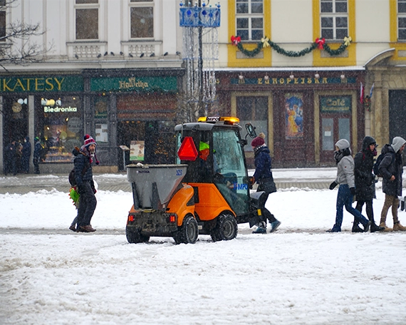 snow removal image three snow removal tractor removing snow from road and walkway