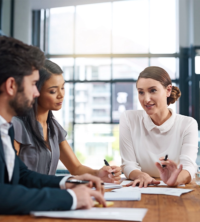 team works two women and one man in team discussing about project sitting in office