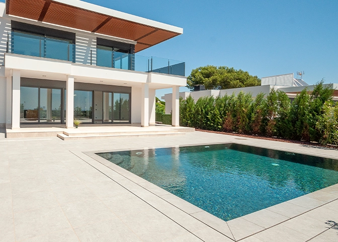traditional chlorine pool with tiles floor in front of modern home