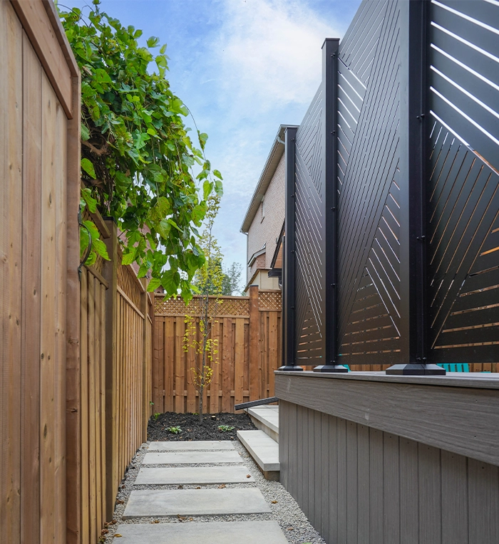 walkway between fence and privacy screen, back view of outdoor privacy screen