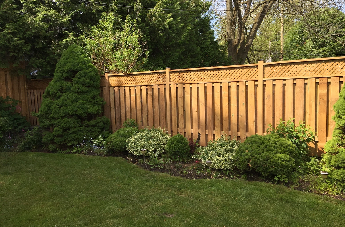 wooden fence with landscaping in lawn