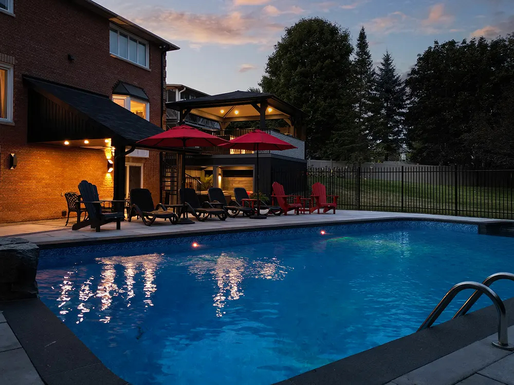 lighting features in a pool in a backyard of a large home