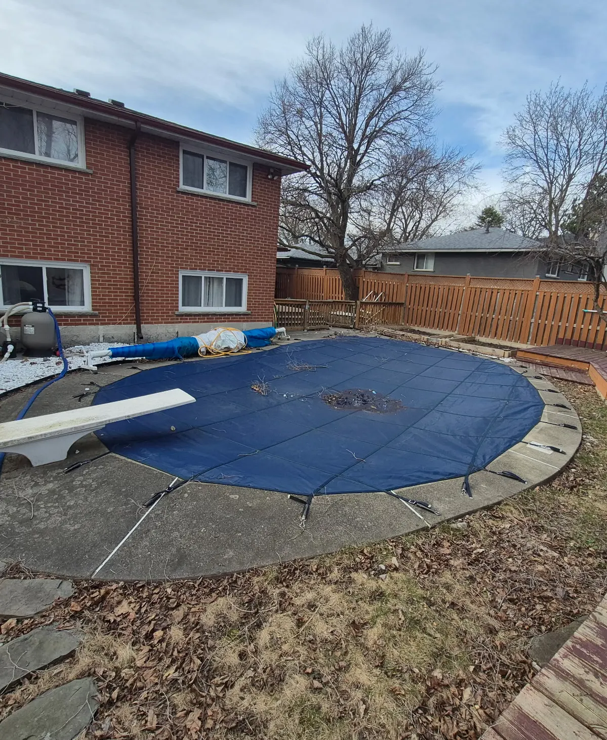 old pool in need of restoration with the cover on