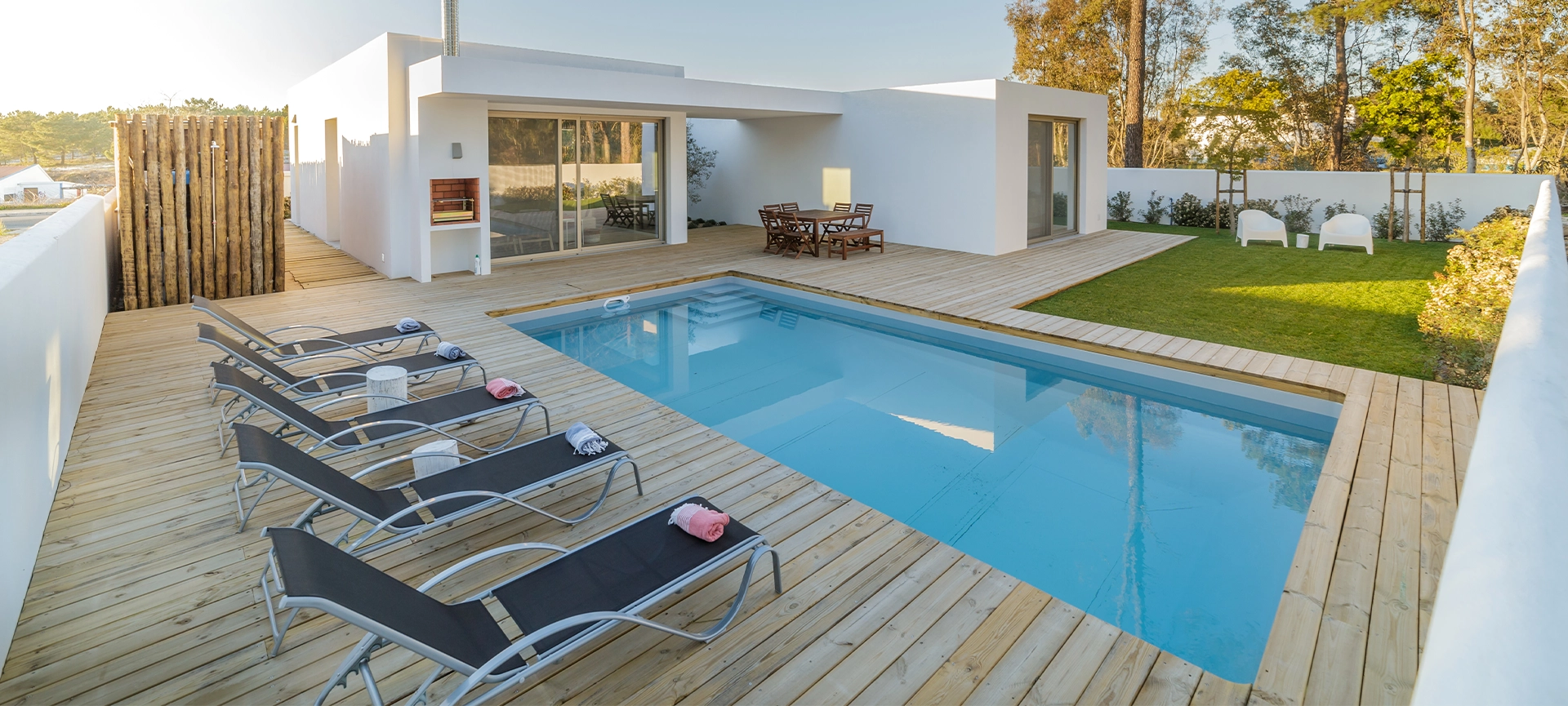 Modern house with garden swimming pool and wooden deck