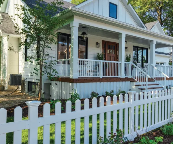 large white house with a brand new white picket fence