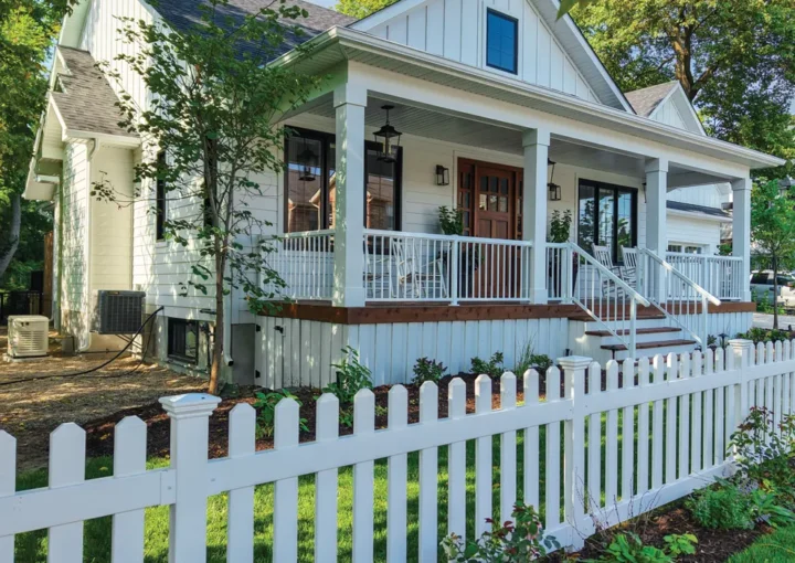 large white house with a brand new white picket fence