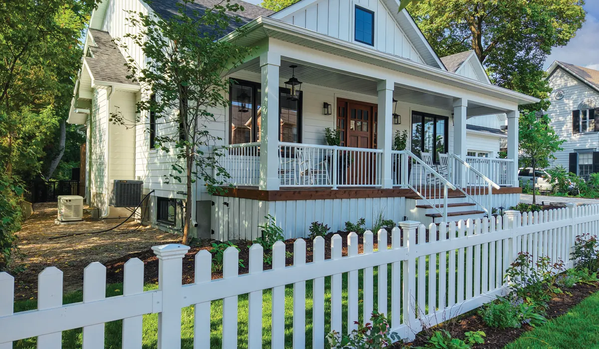 large white house with a brand new white picket fence