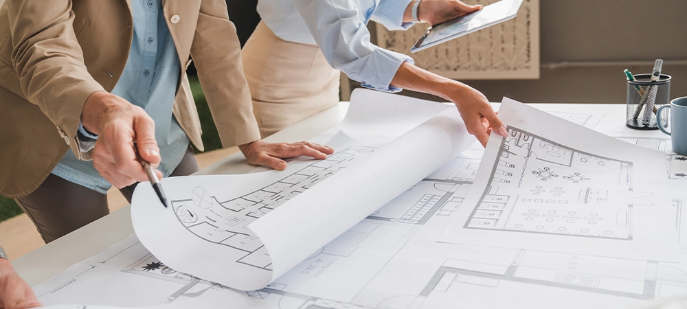 Architects and engineers are in a meeting to discuss and inspect the house designs to meet the building and construction standards. Interior design and decoration ideas.