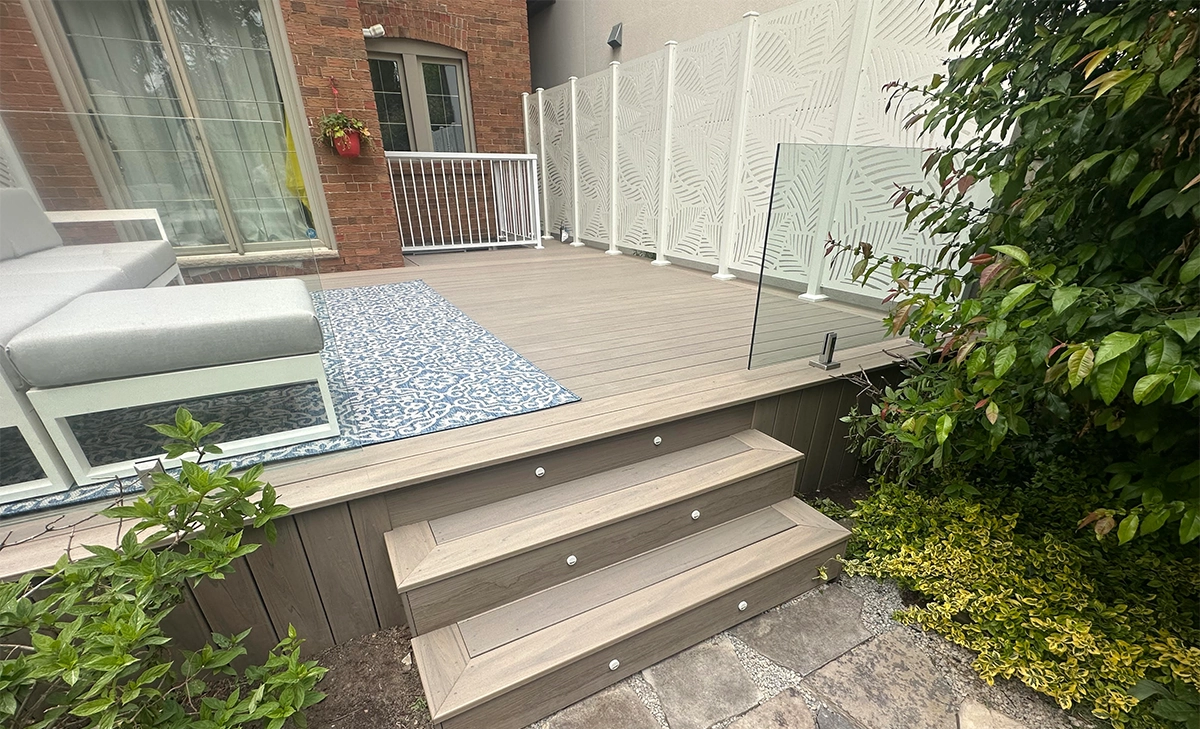 toronto deck restoration built in lighting feature in steps, deck with glass railing, privacy screen, seating setup, deck restoration