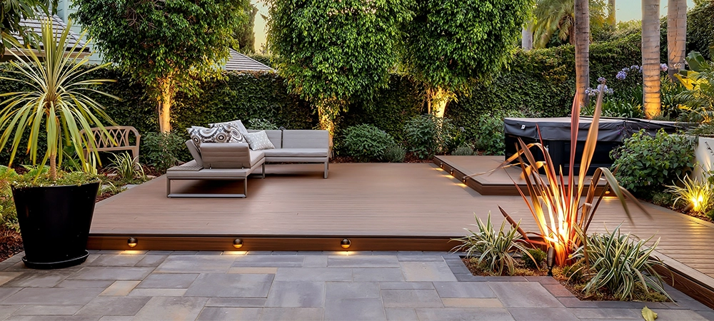 Modern Backyard Deck with Hot Tub and Ambient Lighting at Sunset