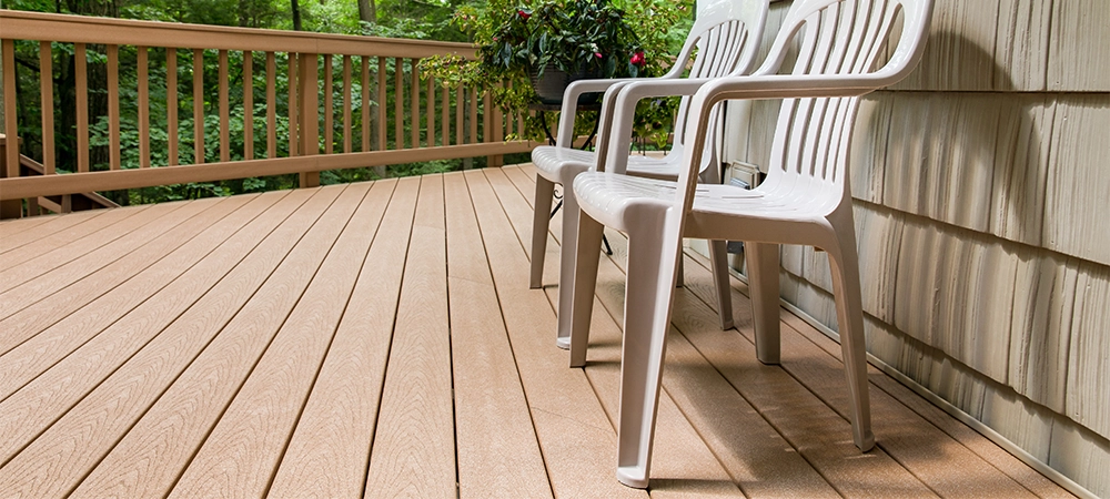 Two chairs on an outdoor deck in the woods. Relaxing and welcoming outdoor scene.